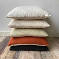 Stack of plain colour Tess cushions