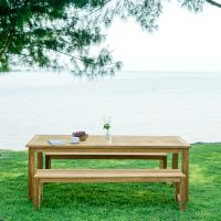 Balmoral Outdoor Teak Dining table + Bench a on grass by water